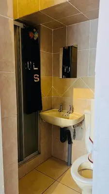 a bathroom with a sink and a toilet at Drostdy Hotel in Springs