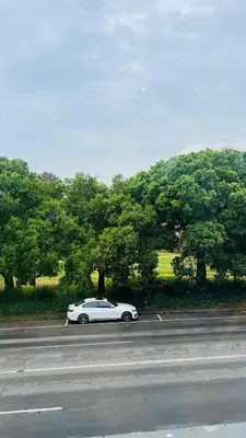 a white car parked on the side of a road at Drostdy Hotel in Springs