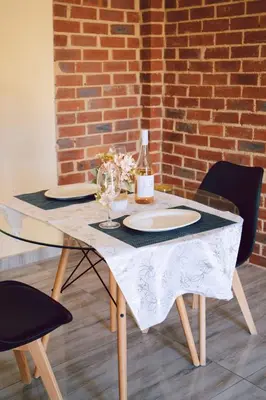 a table with two plates and a bottle of wine at L a Grande deluxe in Benoni
