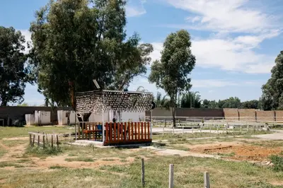 a wooden structure in the middle of a field at L a Grande deluxe in Benoni