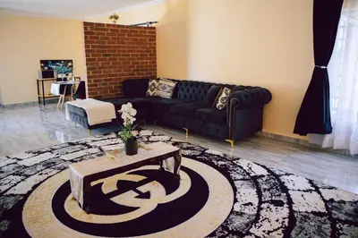 a living room with a couch and a table at L a Grande deluxe in Benoni