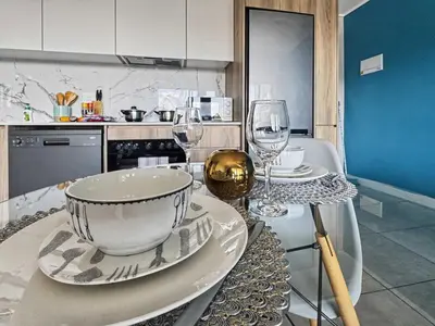 a table with wine glasses and a bowl on it at Resort style 1BR-Big balcony-Lagoon Luxury Spa in Midrand