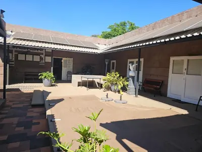 a patio with a table and chairs on a building at Luxury Meets Convenience Near City & Travel Links in Pretoria