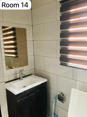 a bathroom with a sink and a mirror at The Bright Guest House in Pretoria