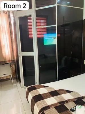 a room with a bed and a glass door at The Bright Guest House in Pretoria