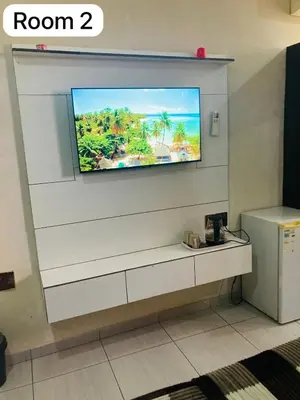 a flat screen tv on a wall in a room at The Bright Guest House in Pretoria