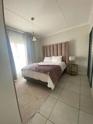 a bedroom with a large bed and a window at The Dream Escape At The Blyde - 2 Bedroom Apartment in Pretoria