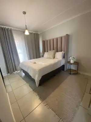 a bedroom with a large bed in a room at The Dream Escape At The Blyde - 2 Bedroom Apartment in Pretoria