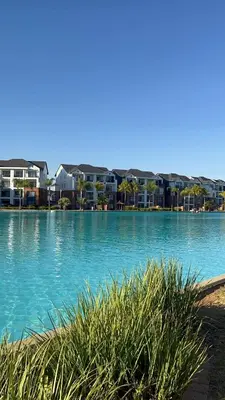 a large body of water with buildings in the background at The Dream Escape At The Blyde - 2 Bedroom Apartment in Pretoria