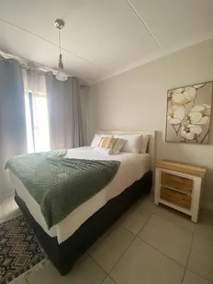 a bedroom with a large bed and a window at The Dream Escape At The Blyde - Lagoon Facing 3 Bedroom Apartment in Pretoria