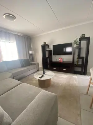 a living room with a couch and a tv at The Dream Escape At The Blyde - Lagoon Facing 3 Bedroom Apartment in Pretoria