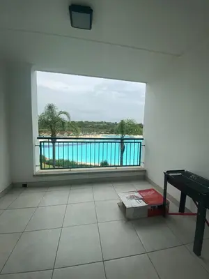 a room with a large window with a view of the water at The Dream Escape At The Blyde - Lagoon Facing 3 Bedroom Apartment in Pretoria