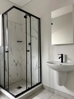 a bathroom with a glass shower and a sink at The Dream Escape At The Blyde - Lagoon Facing 3 Bedroom Apartment in Pretoria