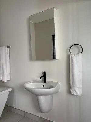 a white bathroom with a sink and a mirror at The Dream Escape At The Blyde - Lagoon Facing 3 Bedroom Apartment in Pretoria