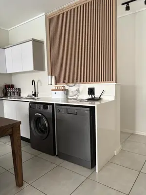 a kitchen with a dishwasher and a washing machine at The Dream Escape At The Blyde - Lagoon Facing 3 Bedroom Apartment in Pretoria