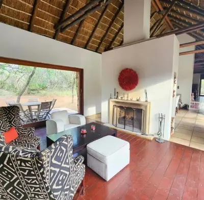 a living room with couches and a fireplace at Mokaikai - Pride Retreat - Pax 10 in Bobbejaanstert