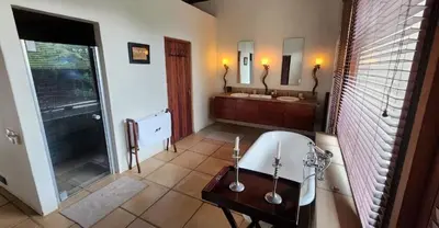 a bathroom with two sinks and a bath tub at Mokaikai - Pride Retreat - Pax 10 in Bobbejaanstert