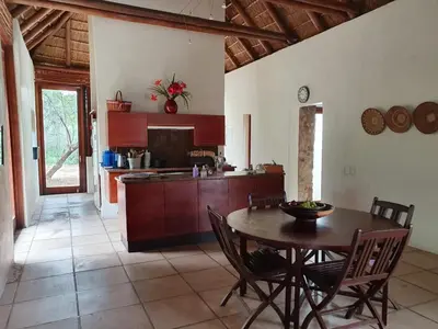 a kitchen and dining room with a table and chairs at Mokaikai - Pride Retreat - Pax 10 in Bobbejaanstert