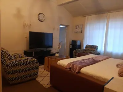 a bedroom with a bed and a flat screen tv at Portia inn accommodation in Pretoria
