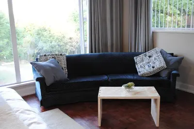 a living room with a blue couch and a table at B and B Sandton in Johannesburg