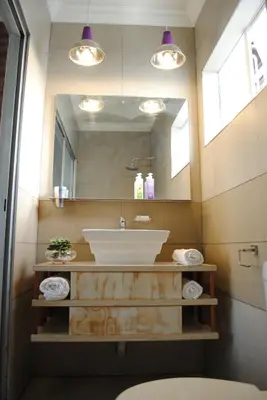 a bathroom with a sink and a mirror at B and B Sandton in Johannesburg