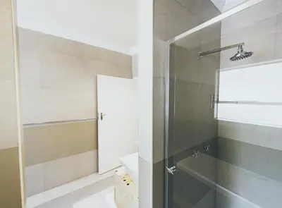 a bathroom with a shower with a glass door at B and B Sandton in Johannesburg
