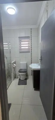 a bathroom with a toilet and a sink and a shower at Good night guest house in Polokwane