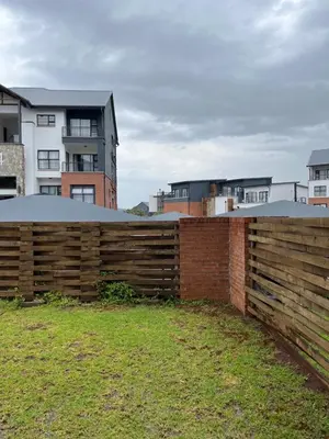 a wooden fence in front of some buildings at Lux Easy Stay in Pretoria