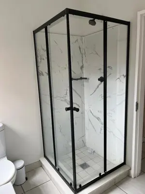 a glass shower in a bathroom with a toilet at Lux Easy Stay in Pretoria