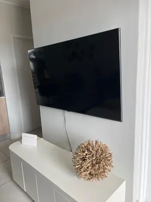 a flat screen tv on a white entertainment center at Lux Easy Stay in Pretoria
