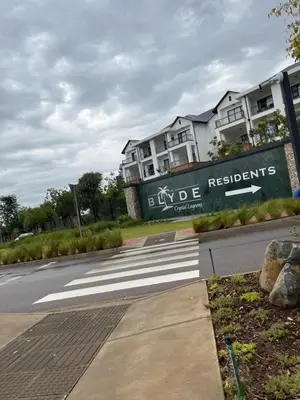 a building with a sign on the side of a road at Lux Easy Stay in Pretoria