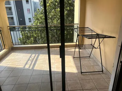 a balcony with a metal table on a balcony at Spacious Apartment Near Gautrain, Gallagher & MOA in Midrand