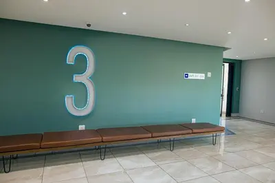 a bench with a number three on a wall at Regency Apartment Hotel Unit 311 in Pretoria