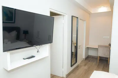 a living room with a large flat screen tv on a wall at Regency Apartment Hotel Unit 311 in Pretoria
