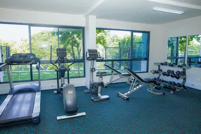 a gym with several treadmills and machines in a room at Regency Apartment Hotel Unit 311 in Pretoria