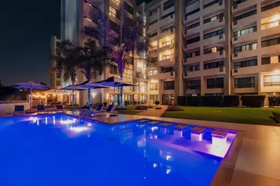 a swimming pool in front of a building at night at Regency Apartment Hotel Unit 311 in Pretoria