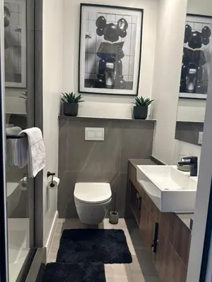a bathroom with a toilet and a sink at Modern Studio Apartment in The Capital Trilogy in Pretoria