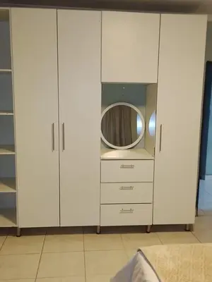 a white cabinet with a mirror in it at A home away from Home in Musina