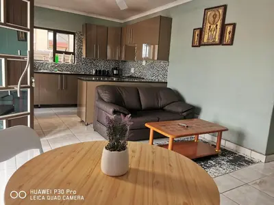 a living room with a couch and a table at A home away from Home in Musina