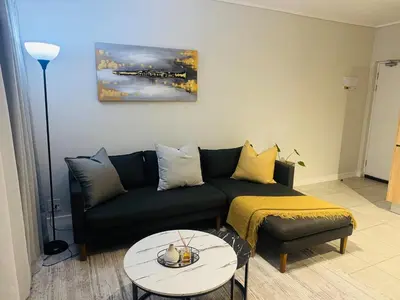 a living room with a couch and a table at Diamond Suite Munyaka in Midrand