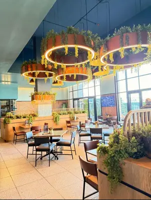 a restaurant with tables and chairs and a large chandelier at Diamond Suite Munyaka in Midrand