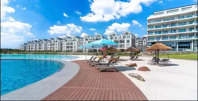 a pool with chairs and umbrellas and a building at Diamond Suite Munyaka in Midrand