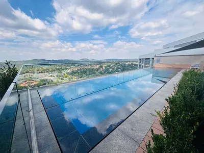 a swimming pool on the roof of a building at Signature Luxury Living Experience - The Trilogy Collection in Pretoria