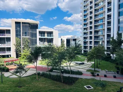 an apartment complex with tall buildings and a park at Signature Luxury Living Experience - The Trilogy Collection in Pretoria