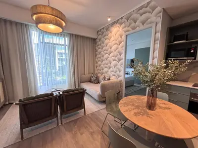 a living room with a table and a couch at Signature Luxury Living Experience - The Trilogy Collection in Pretoria