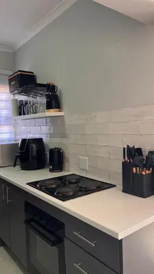 a kitchen with a stove and a counter top at UrbanCharm home away from home Affordable Luxury in Polokwane