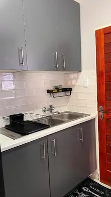 a kitchen with a sink and a counter top at UrbanCharm home away from home Affordable Luxury in Polokwane