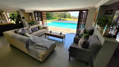a living room with a couch and chairs and a pool at Panorama View Pool House Steiltes in Nelspruit