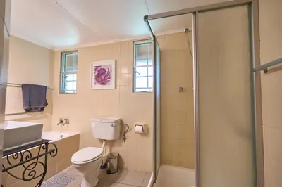 a bathroom with a toilet and a sink and a shower at Sable Ranch Selfsorg in Brits