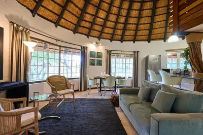 a living room with a couch and a table at Sable Ranch Selfsorg in Brits